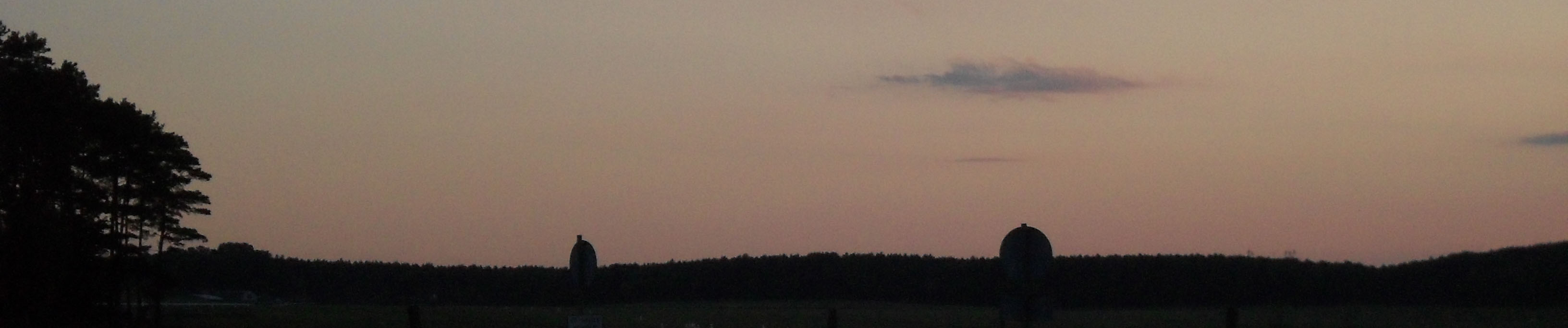 Underexposed picture of an open space, taken during an August sunset