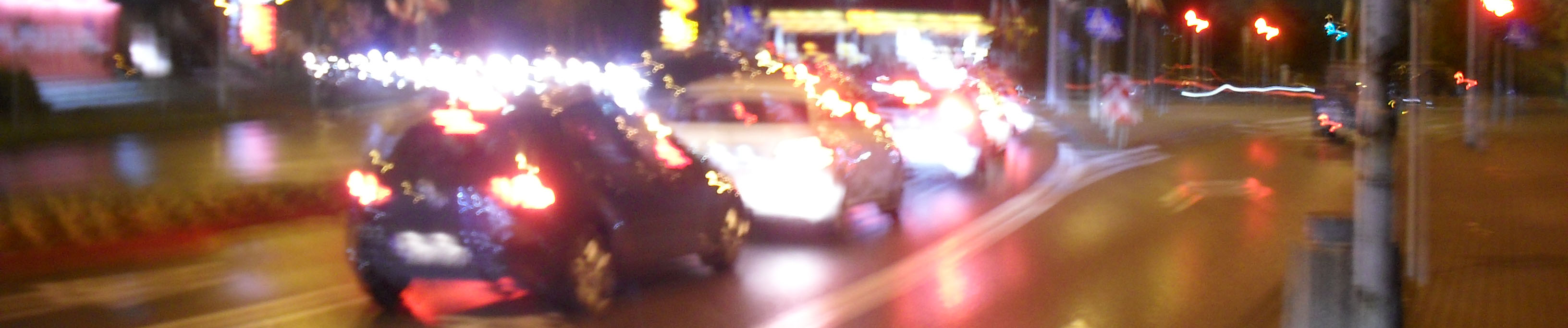 Cropped picture of a busy street at night.
